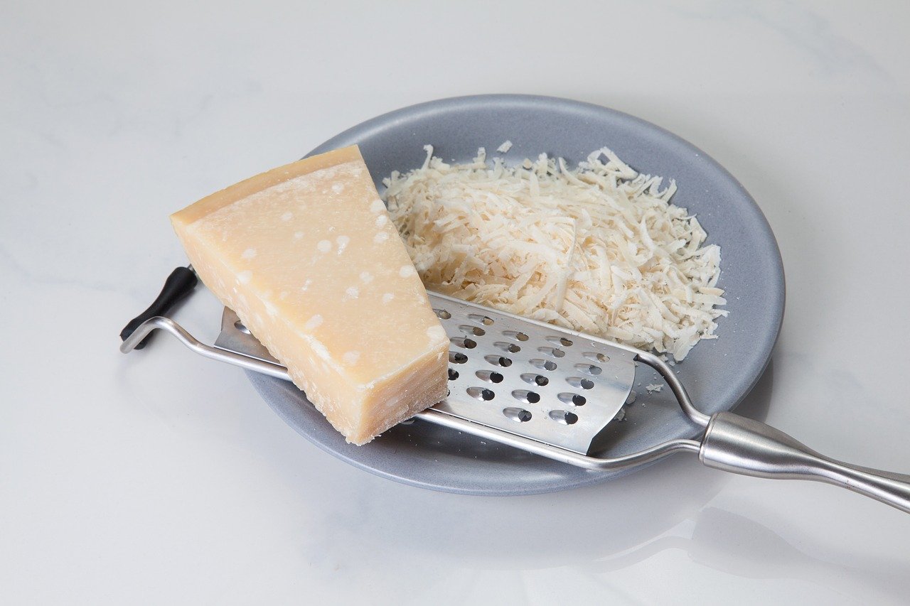Bowl with grated parmesan Parmigiano-Reggiano hard cheese in